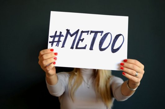 Woman holding a sign with the text #METOO