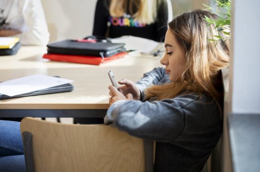 Young woman scrolling her phone 