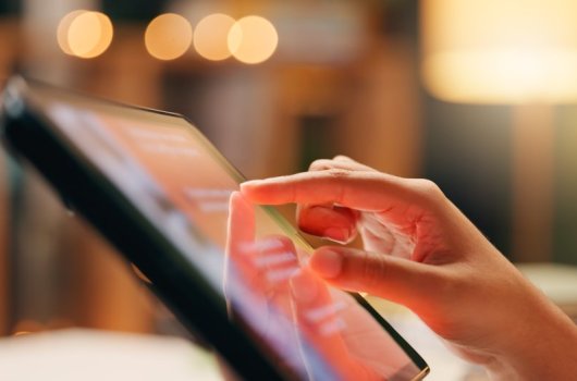 Hands on an Ipad. 