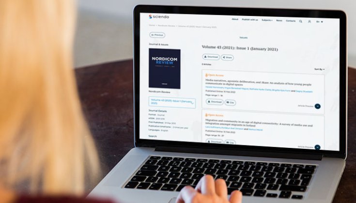 Person reading Nordicom Review on a computer.